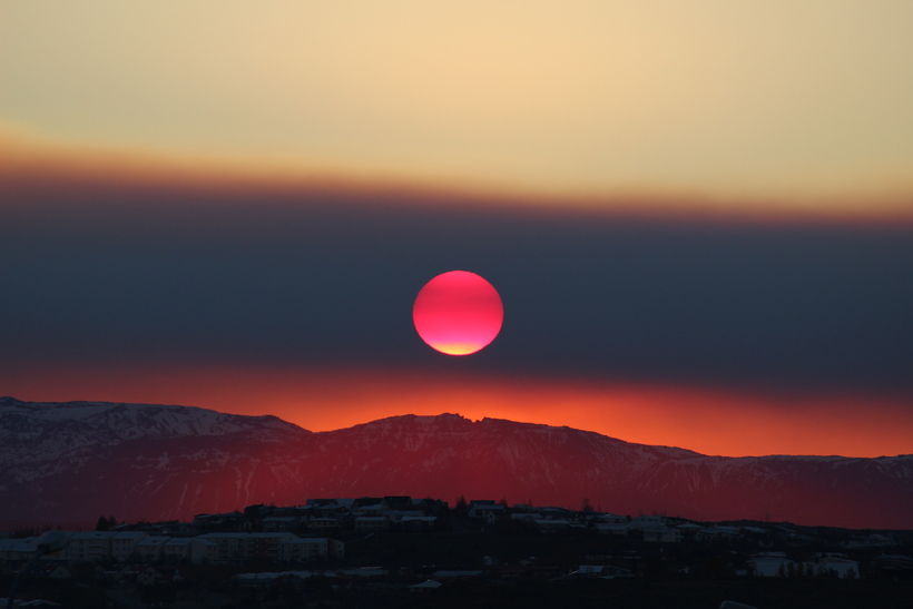 blood red sun rising over reykjavík, ttar sveinsson
